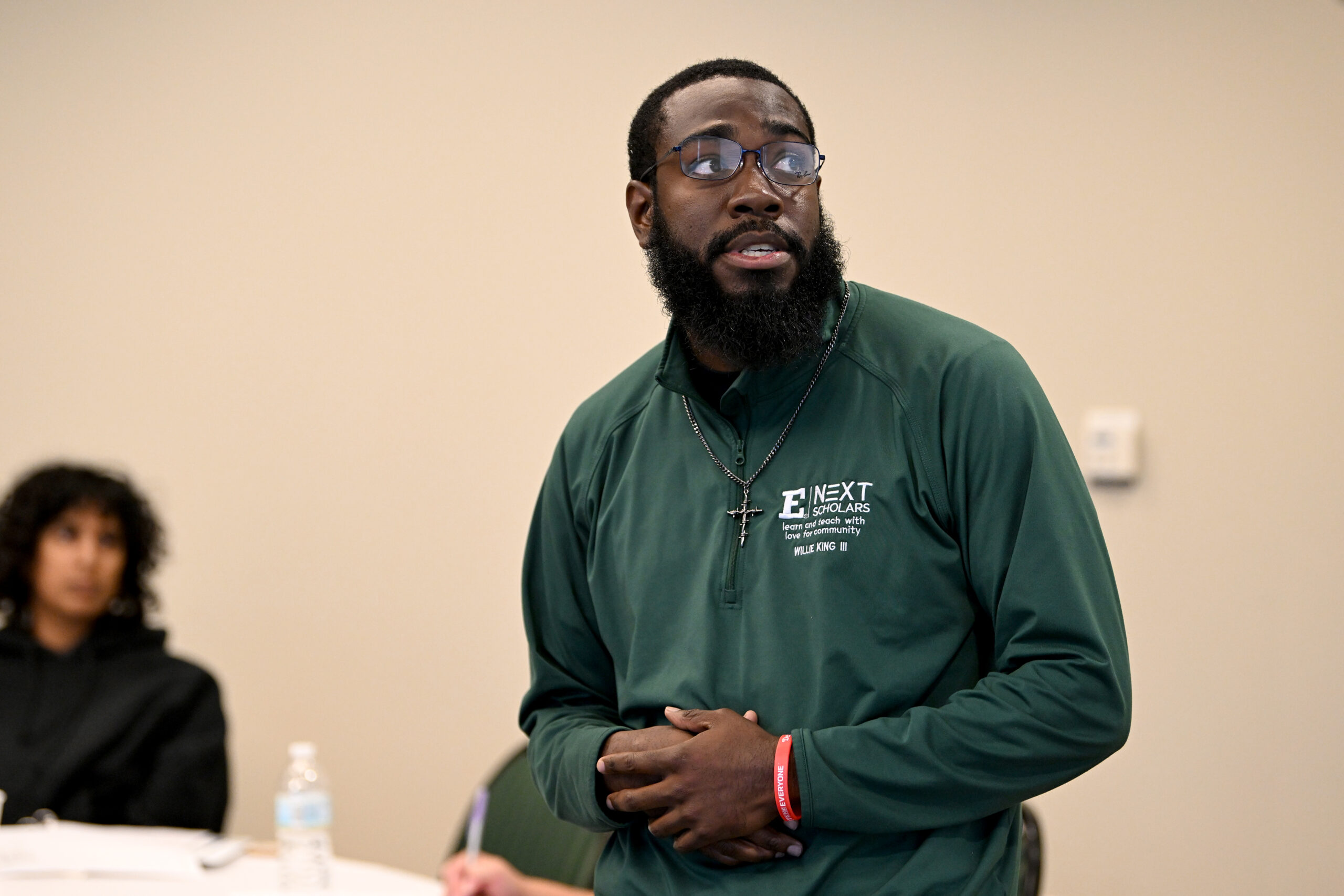 Portrait style photo of SEMIS Program associate Willie King III wearing a dark green sweatshirt and looking off into the distance.