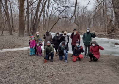 Several members of the SEMIS Coaltion pose for a photo at Rouge Park along the Rouge River. Everyone has one winter gear and it looks quite cold.
