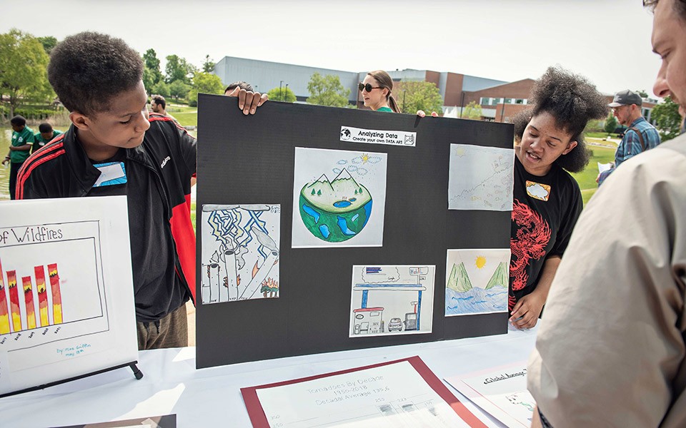 (Above): Students present their posters from their year-long Climate Change project at the 2023 SEMIS Coalition Community Forum. Photo by Leisa Thompson.